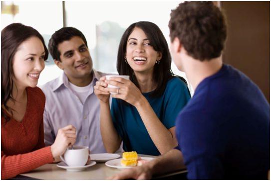 men and women having a talk and coffee