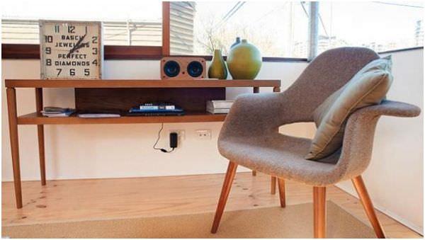 a chair and table with clock and radio