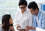 Two men and women talking at workplace