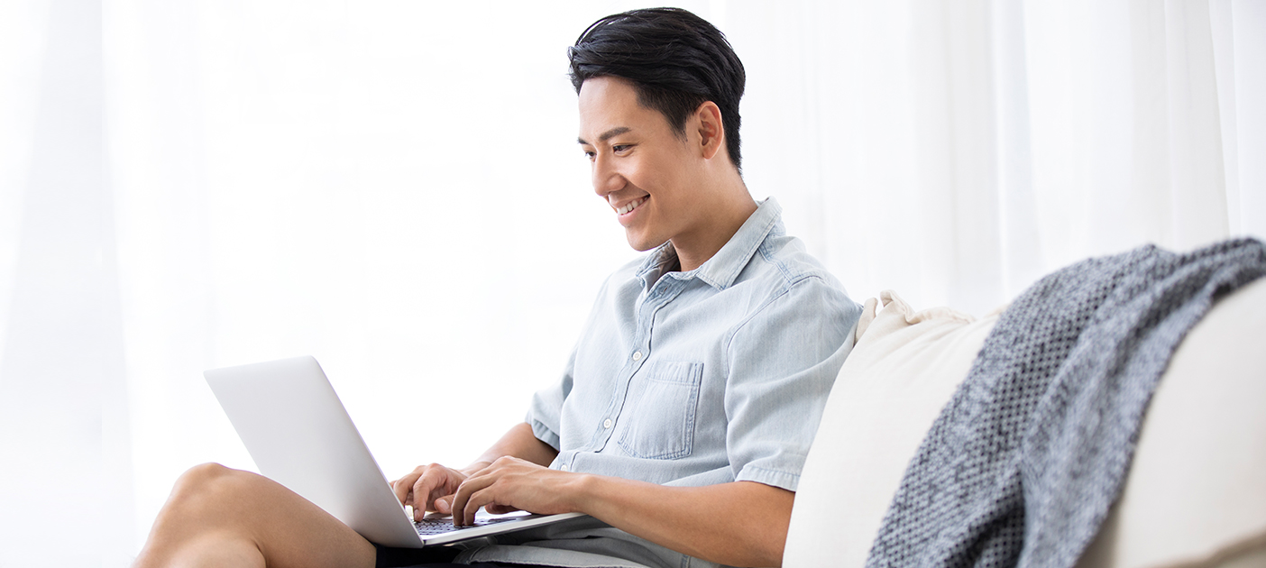 Young man researching on his laptop on endowment plans and investment-linked plans