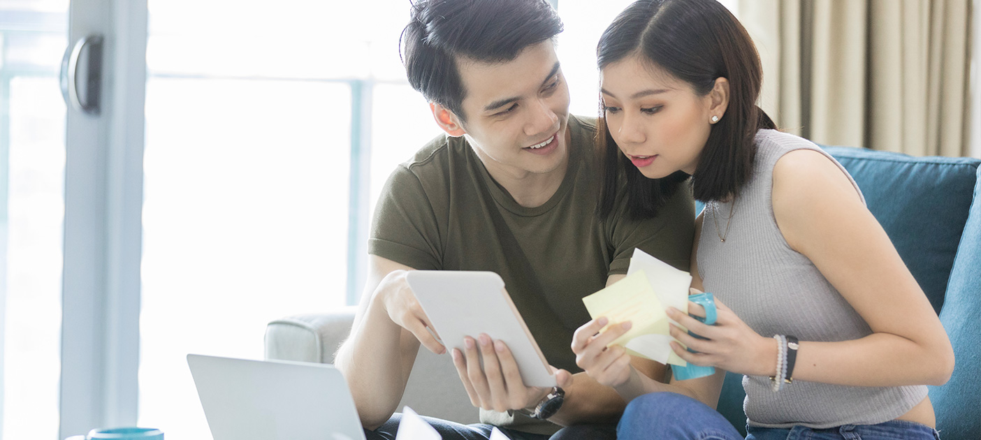 Young couple comparing home loans to decide on the right one.