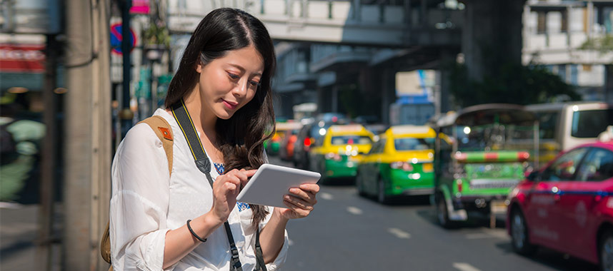 Woman traveller looking at her tablet