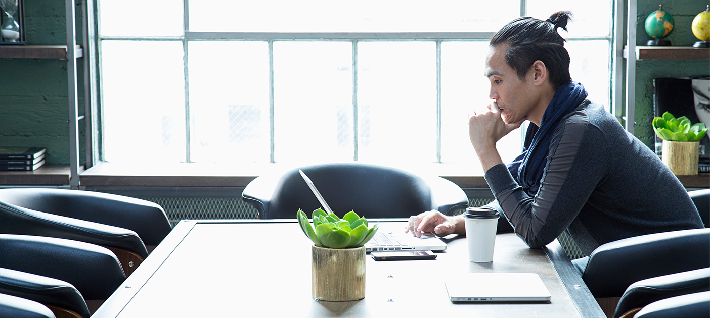 Man using laptop to study the risk level of his investments