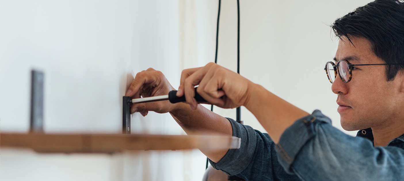 Man fixing up his own furnishings.