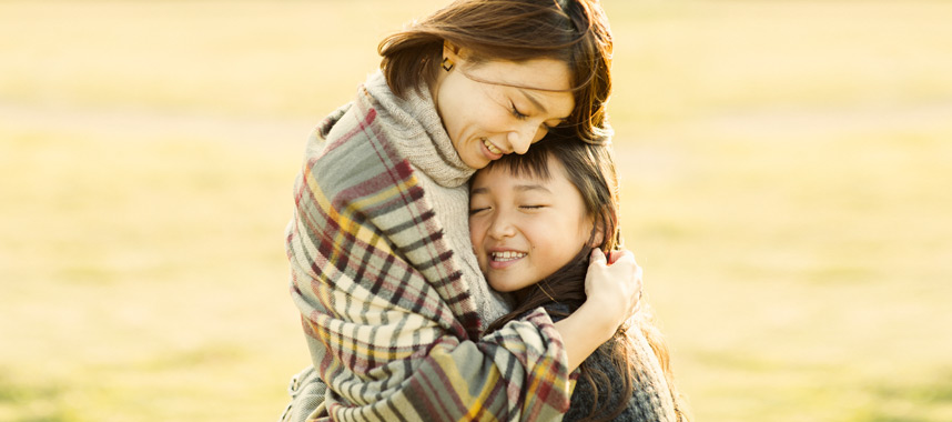 A mother hugs her daughter