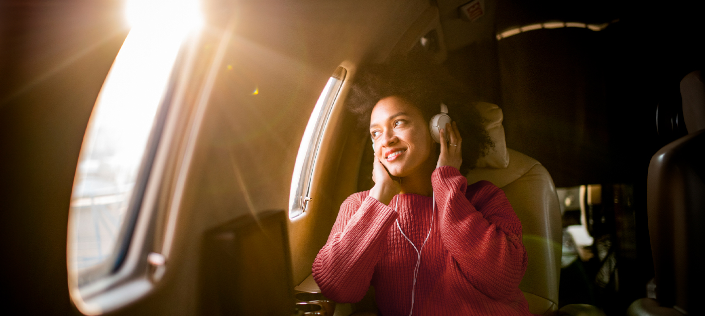 Happy Young Woman Enjoying Music and Smiling
