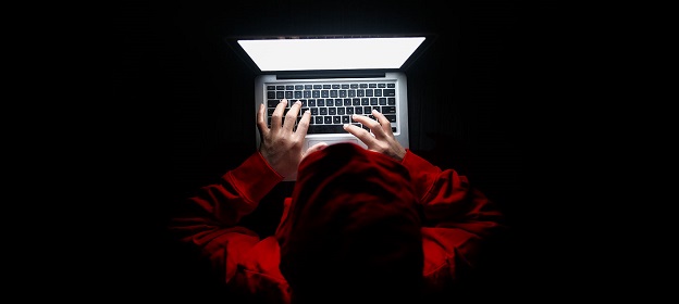 Hacker using laptop - How your cyber security may be compromised