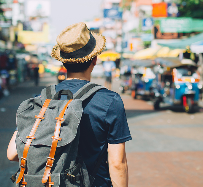 Young male traveller backpacking around Asia